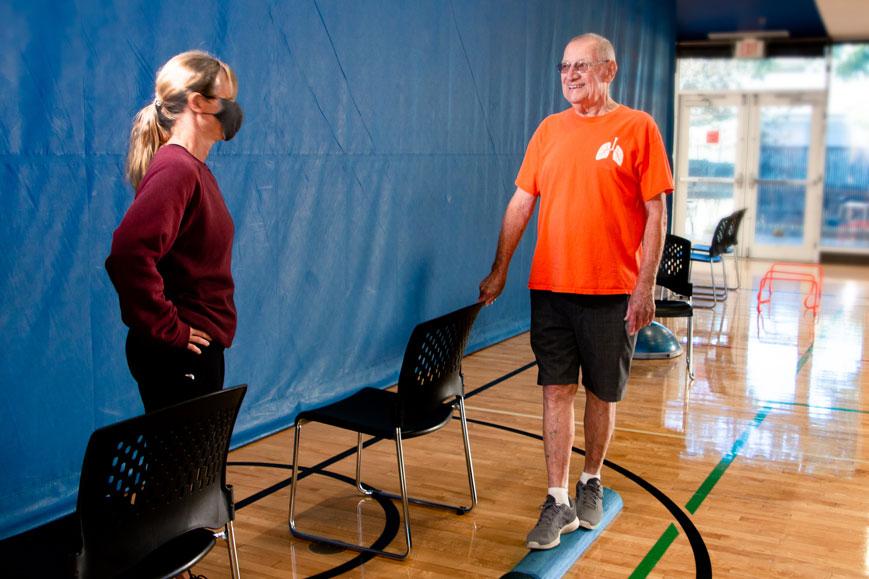 Bob working with a trainer on balance